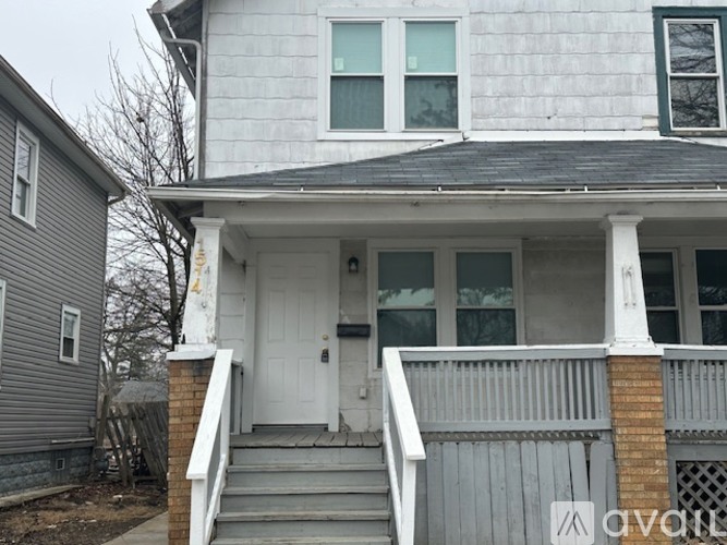 A house with a white door and a small porch.