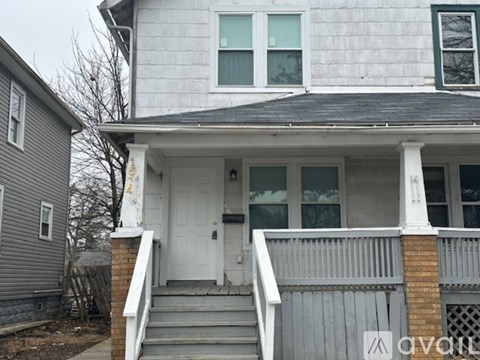 A house with a white door and a small porch.