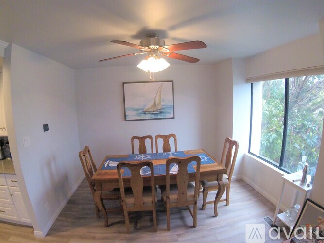 A dining room with a table and chairs.