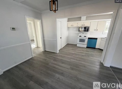 A kitchen with a blue counter and wooden floors.