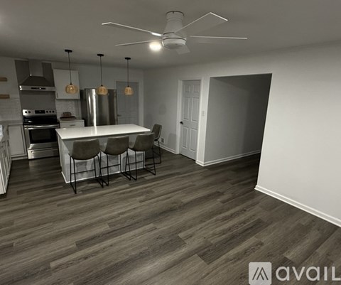 A modern kitchen with a dining table and chairs.