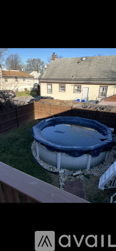 A hot tub is in the backyard.