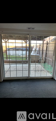 A view from inside a room looking out through a sliding glass door.