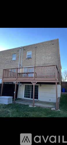 A house with a balcony and a garage door.