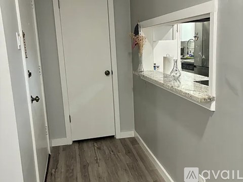 A white door with a black handle is closed.