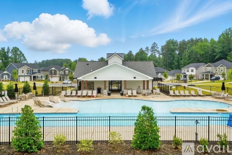 A large house with a pool in front of it.