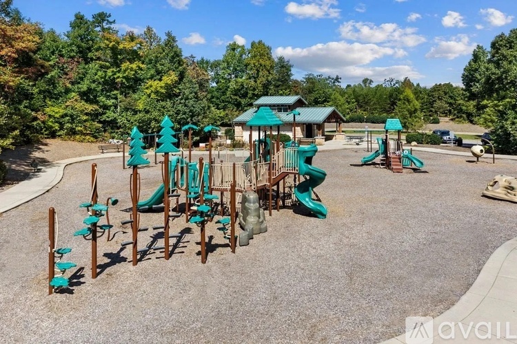 A playground with a green roof and a slide.