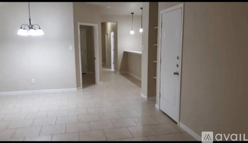 A room with a tiled floor and a white door.