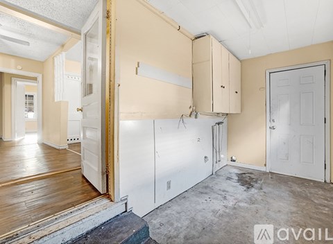 A room with a ceiling fan and wooden flooring.