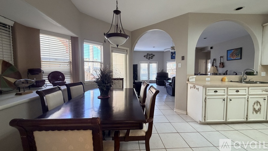A dining room with a wooden table and chairs.