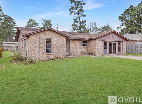 A house with a brown roof and a tree in the background.
