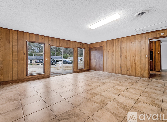 A house with a stone exterior is available for rent.