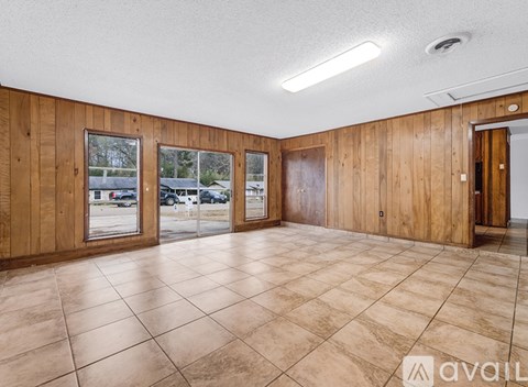 A house with a stone exterior is available for rent.