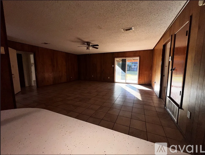 A room with wooden walls and a tiled floor.
