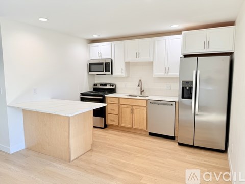 A kitchen with wooden cabinets and stainless steel appliances.