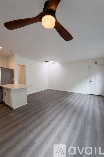 A room with a ceiling fan and a cabinet.