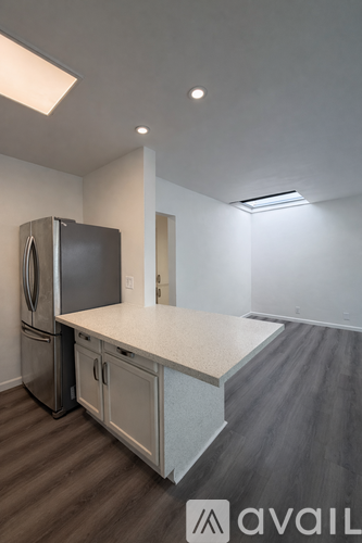 A kitchen with a refrigerator and a countertop.