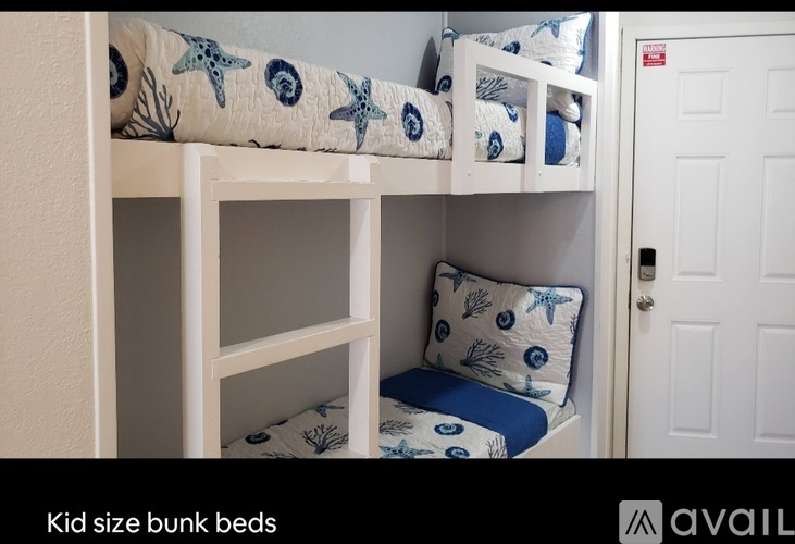 A bunk bed with a blue and white patterned pillow.
