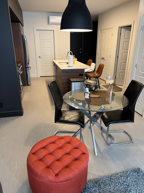 A kitchen with a table and chairs.