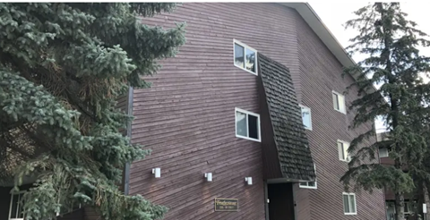 A red building with a black roof and a sign that says "Frontenac".