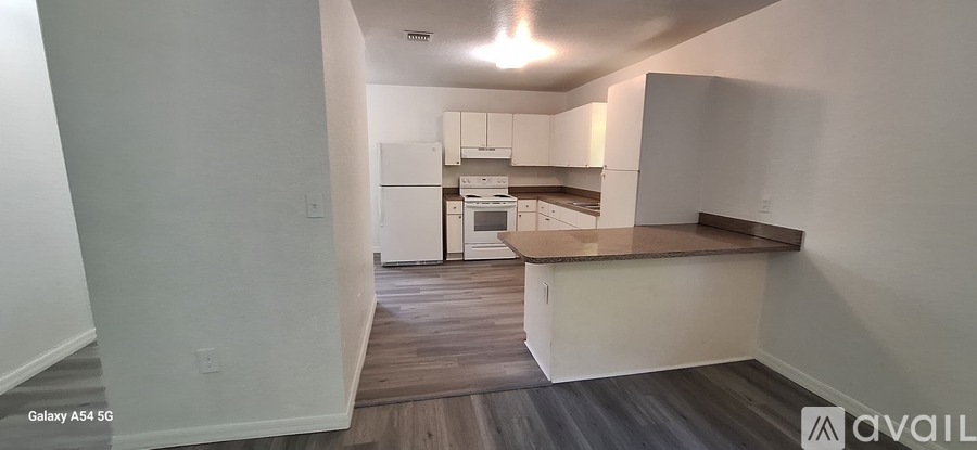 A kitchen with white cabinets and a wooden countertop.