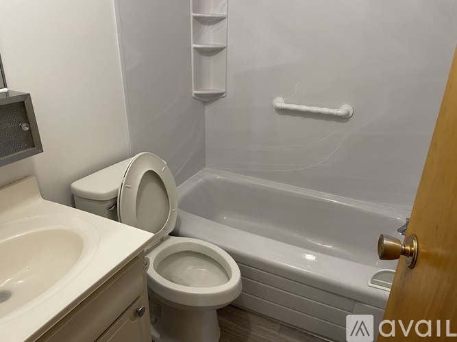 A white toilet sits next to a sink in a bathroom.