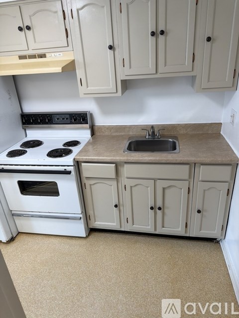 A kitchen with a sink and a pantry.