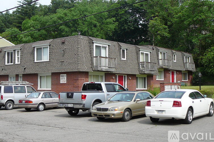 Cars parked in front of a brick building.