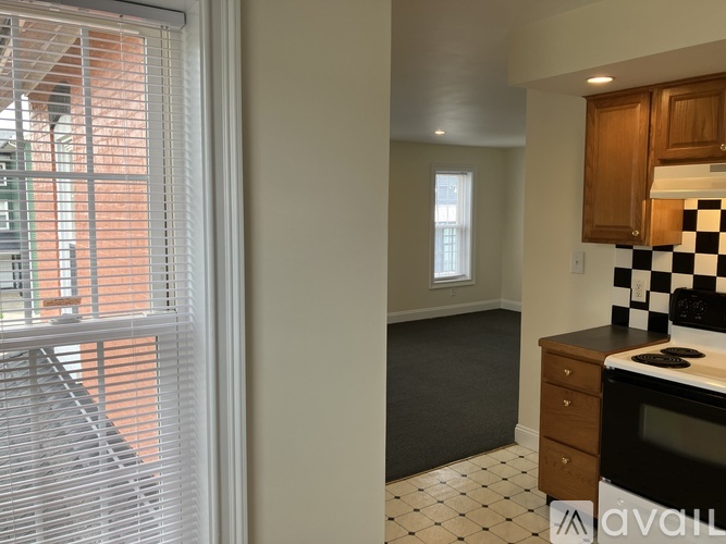 A kitchen with black and white checkered tiles on the counter.