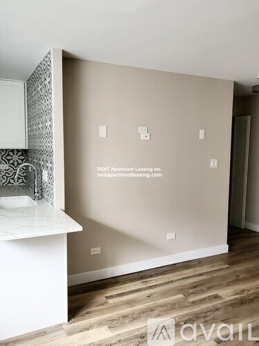 A room with a white counter and a wall with a website address on it.