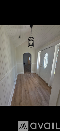 A room with wooden flooring and a ceiling fan.