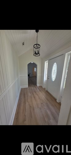 A room with wooden flooring and a ceiling fan.