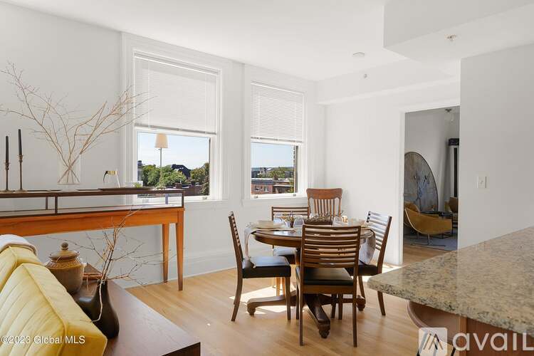 A dining room with a table set for six.