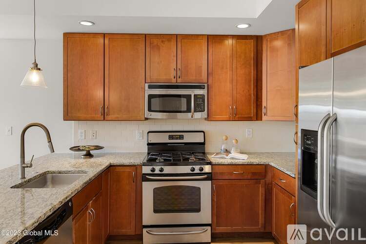 A kitchen with wooden cabinets and stainless steel appliances.