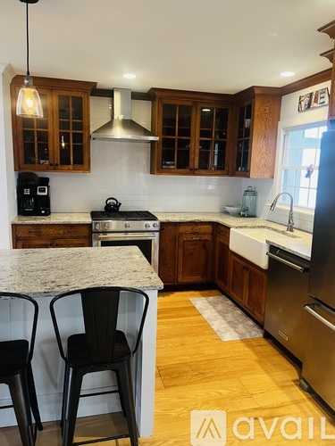 A kitchen with wooden cabinets and a granite countertop.