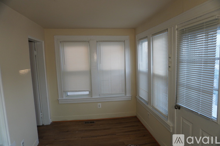 A room with a window and a door.