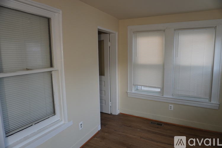 A room with a window and a door.