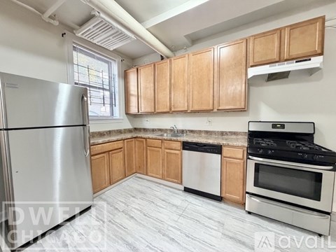 A kitchen with wooden cabinets and stainless steel appliances.