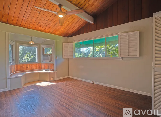 A room with wooden floors and a ceiling fan.