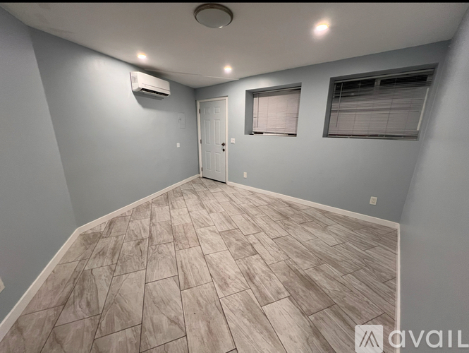 A room with a wooden floor and a door.