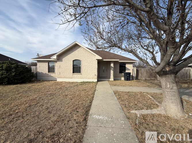 A house with a tree in front of it.