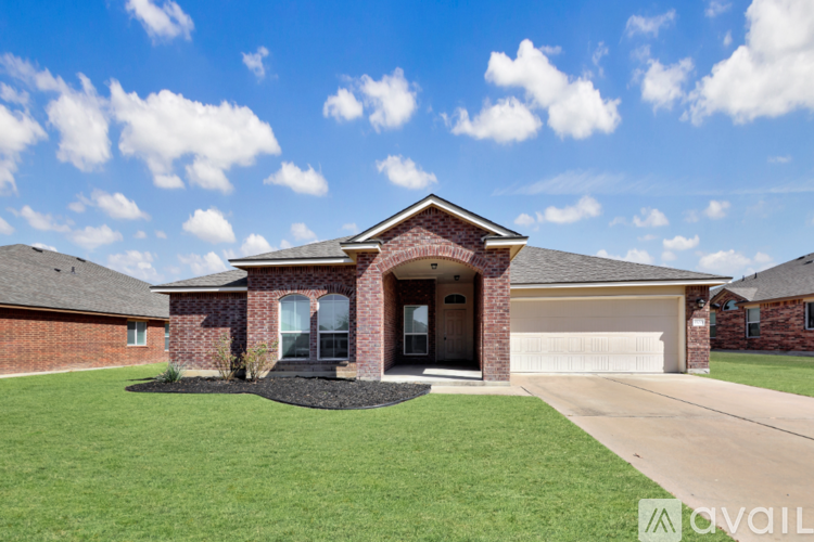 A house with a brick facade and a large front yard.