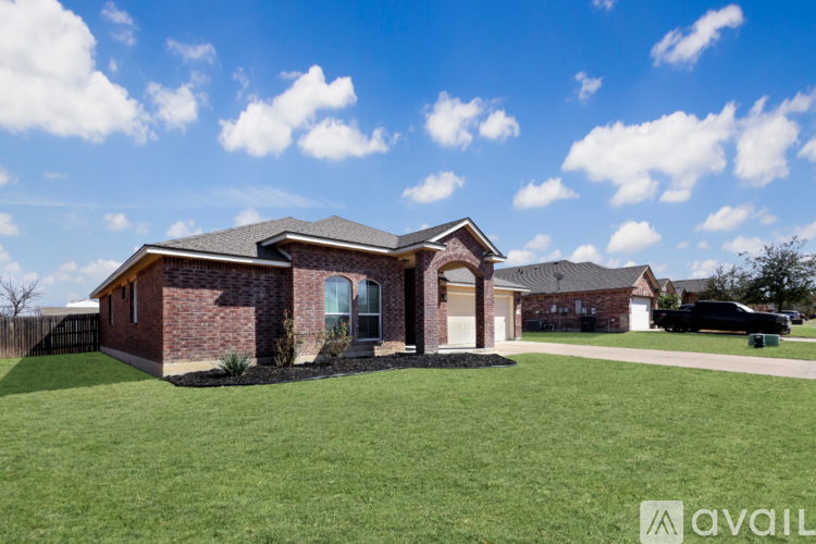 A house with a brick exterior and a large front yard.