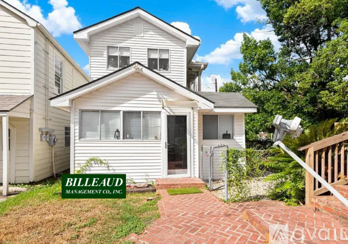 A house with a sign that says Billeaud Management Co. in front of it.