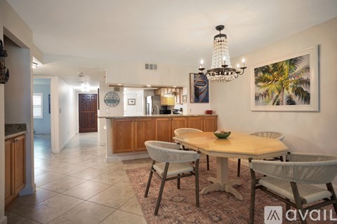 A dining room with a table set for four.