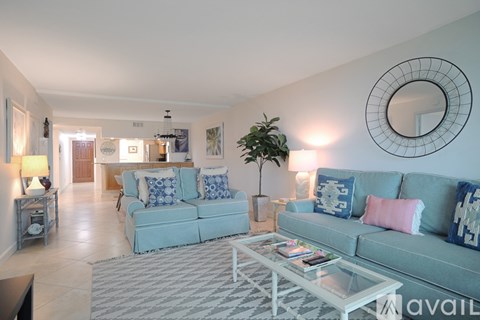 A living room with a grey couch and a coffee table.