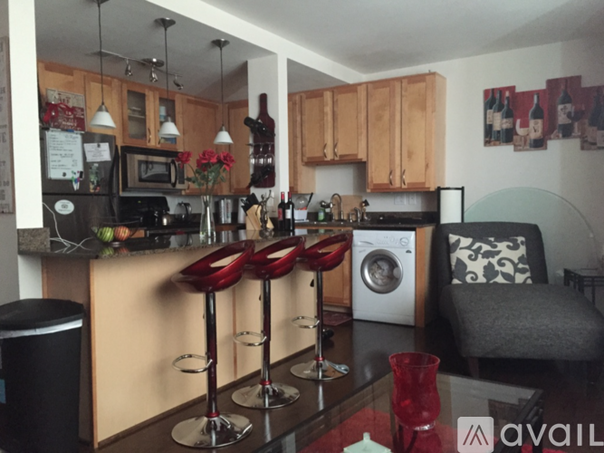 A kitchen with a bar area and a washing machine.