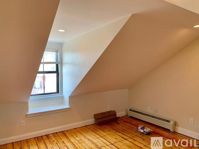 A room with wooden floors and a window.