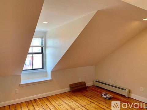 A room with wooden floors and a window.