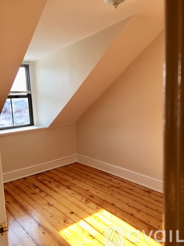 A room with wooden floors and white walls.
